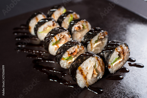 Japanese traditional roll with eel on black background