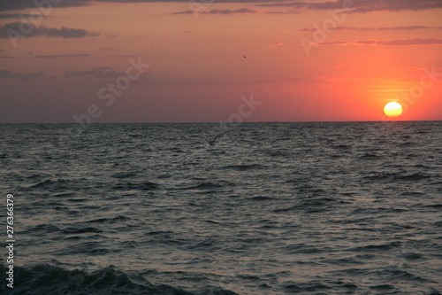 The setting sun going beyond the horizon of the Azov sea