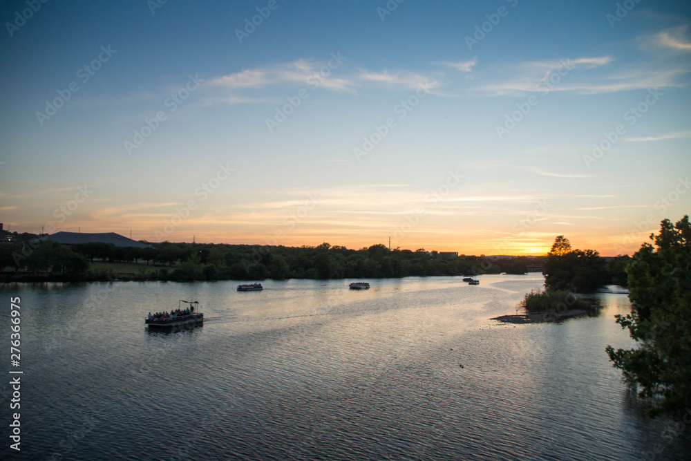 View over boats at Colorado river at sunset, Texas.