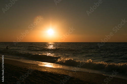 The setting sun going beyond the horizon of the Azov sea