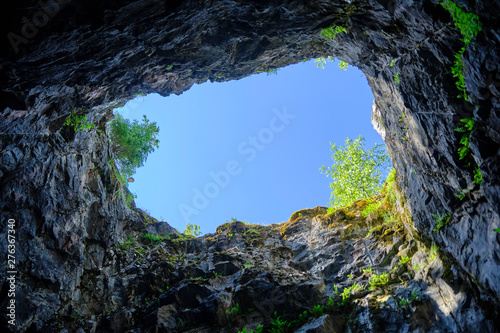 Scenic view of cave near abandoned marble mine in Ruskeala national park in Karelia. Beautiful summer sunny look of grotte in popular touristic canyon on the North of Russian Federation
