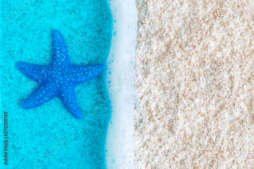 Flat lay of blue starfish in sea near cost abstract.