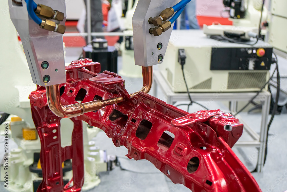 The robotic for spot welding the automotive frame parts. The hi-technology automobile assembly manufacturing process. The robotic for spot welding the automotive frame parts. The hi-technology automobile assembly manufacturing process.