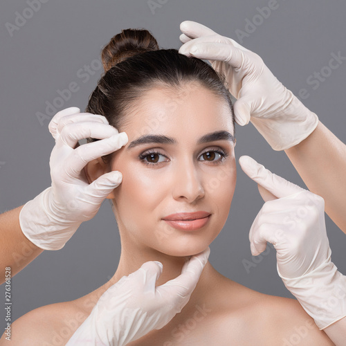 Young woman getting consultation at plastic surgery clinic