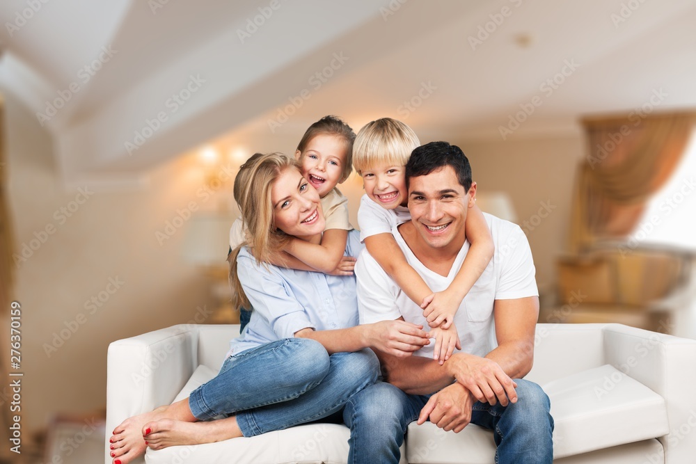 Beautiful smiling family in room on couch Beautiful smiling family in room on couch