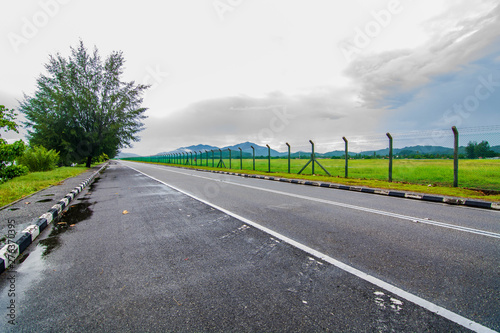 Roadway in Langkawi island surrounded by natural sceneries, mountains and clouds