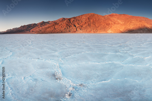 View of the Basins salt flats, Badwater Basin, Death Valley, Inyo County, California, United States. Salt Badwater Formations in Death Valley National Park. Wonderful sunset. Bucket list for roadtrip.