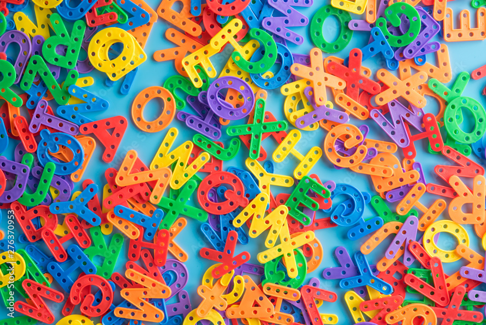 Colorful plastic alphabet letters on blue background,Top view. Colorful plastic alphabet letters on blue background,Top view.