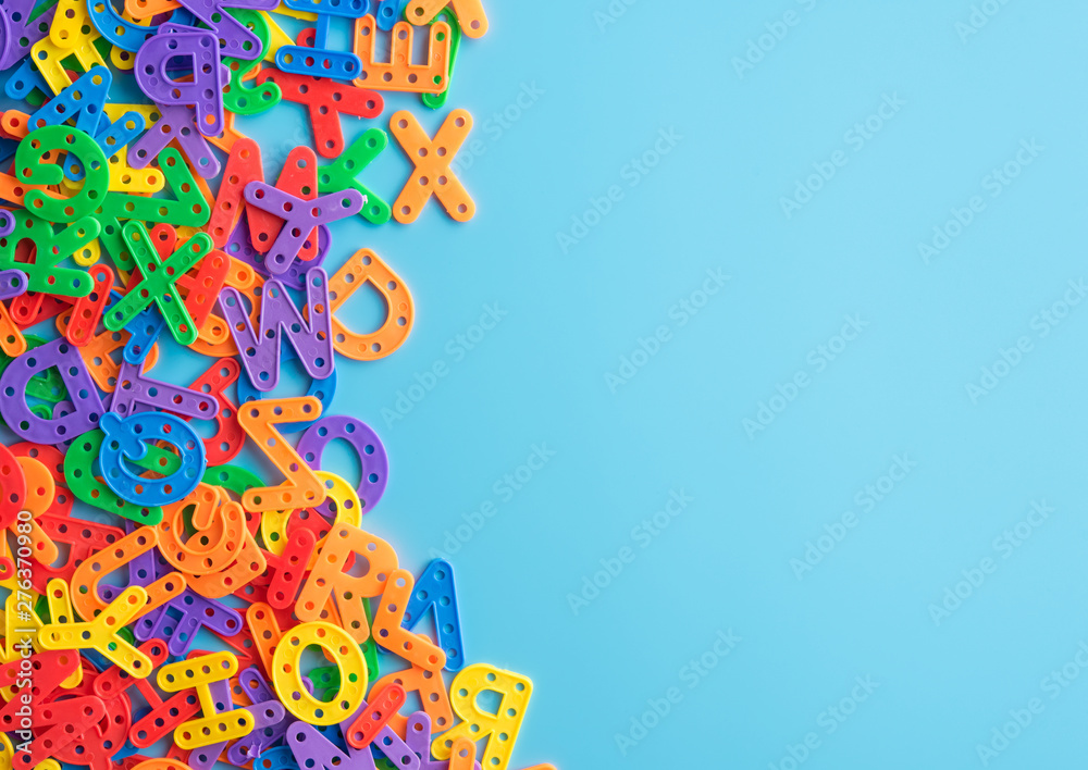Colorful plastic alphabet letters on blue background with copy space,Top view. Colorful plastic alphabet letters on blue background with copy space,Top view.