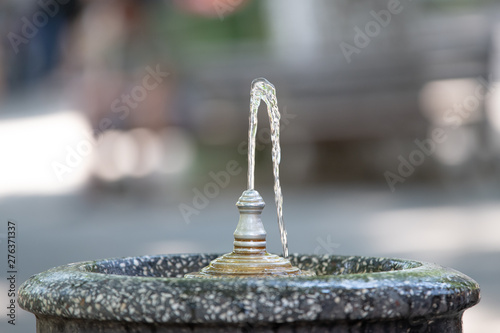 marble little drinking fountain with water photo