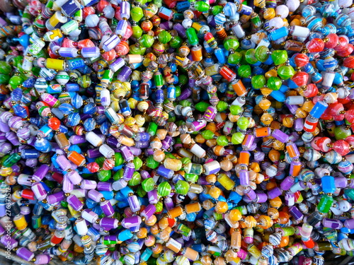 Many, colorful necklaces and bracelets. Close-up, full frame.