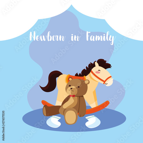 newborn in family card with cute teddy bear and wooden horse