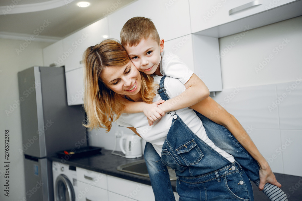 Family in a room. Little boy in a white t-shirt. Mother with son Family in a room. Little boy in a white t-shirt. Mother with son