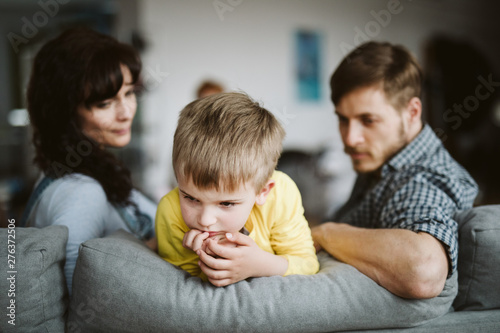 helpless parents and their badly behaving son at home photo