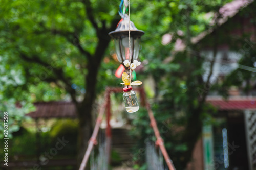 flashlight with colorful ribbons on the cable bridge across the river