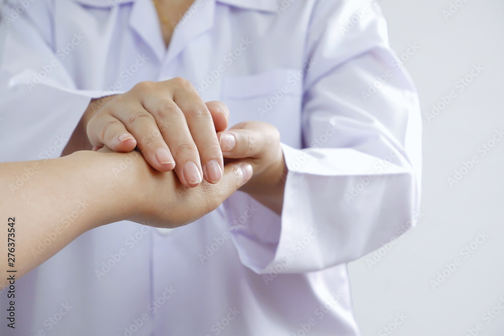 Close up female dotor hands reassuring her patient in medical health care concept, selective focus Close up female dotor hands reassuring her patient in medical health care concept, selective focus