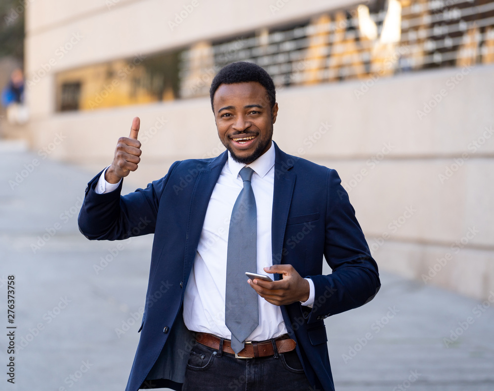 Half length portrait of an attractive stylish and successful businessman outside city street Half length portrait of an attractive stylish and successful businessman outside city street
