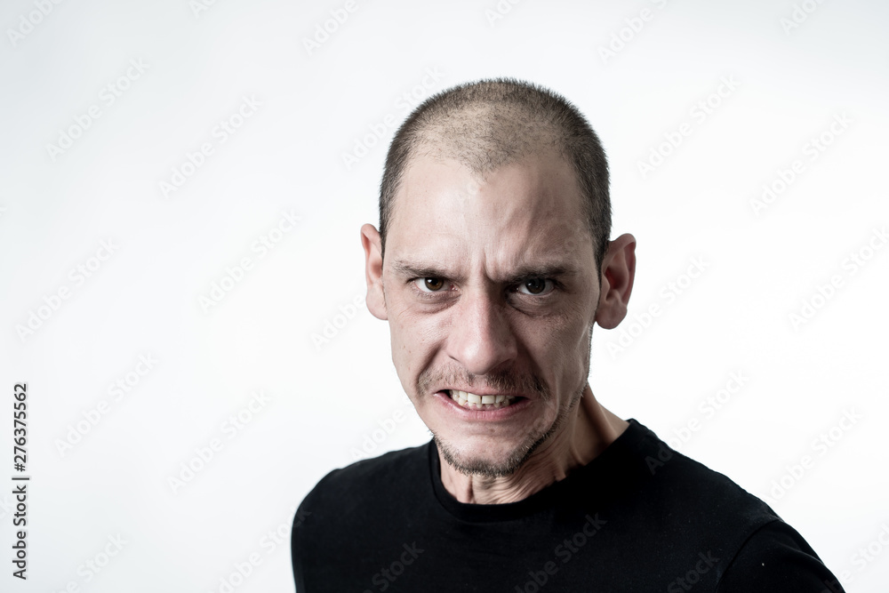 Obraz premium Mad and aggressive guy in facial expressions and negative human emotions