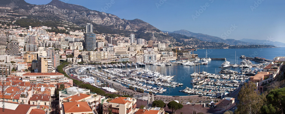 Panoramic view of Monte Carlo in Monaco with red roofs and white yachts. Azur coast. Symbol of luxury life