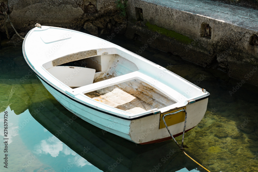 small white open boat in the harbor in Icici. Adriatic Sea, Croatia small white open boat in the harbor in Icici. Adriatic Sea, Croatia