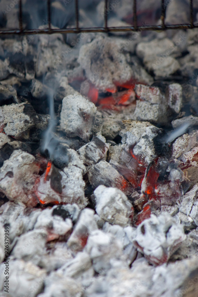 Glowing hot coal ready for cooking, close-up, background texture Glowing hot coal ready for cooking, close-up, background texture