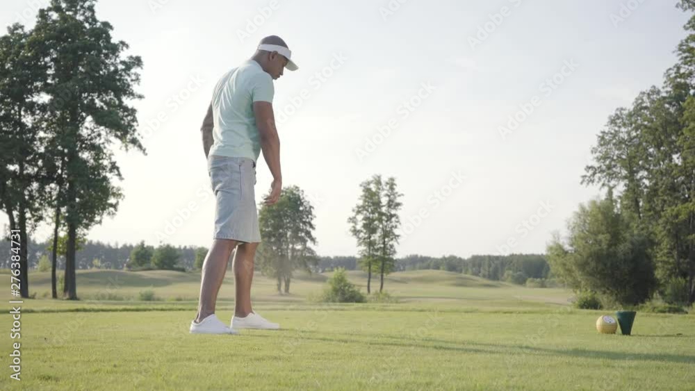 Portrait handsome beginner middle eastern golfer swinging and hitting golf ball on beautiful course. Confident man golfing outdoors. The concept of recreation and sports outdoors. Portrait handsome beginner middle eastern golfer swinging and hitting golf ball on beautiful course. Confident man golfing outdoors. The concept of recreation and sports outdoors.