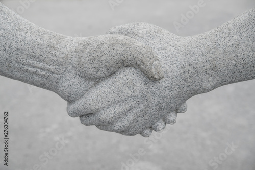 Stone handshake. Concept of cooperation, partnership, team photo