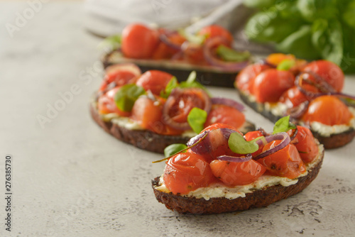 Bruschetta with cherry tomatoes and cheese cream. Healthy, vegan food, snack. photo