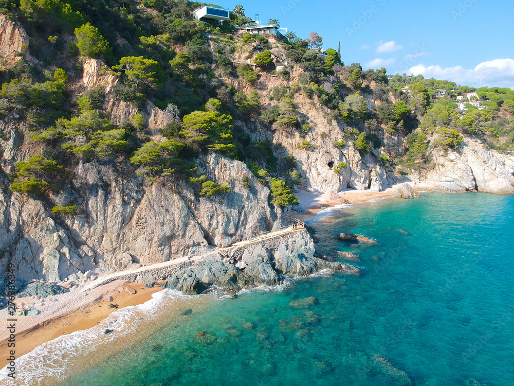 Fototapeta premium Aerial view of beautiful coastline in Mediterranean coast of Spain, Costa Brava. Panorama of Rocks on the coast in beautiful summer day. Beautiful beach with turquoise sea, holiday destination