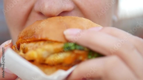 Closeup Of Woman Mouth Eating Vegan Burger. Closeup.