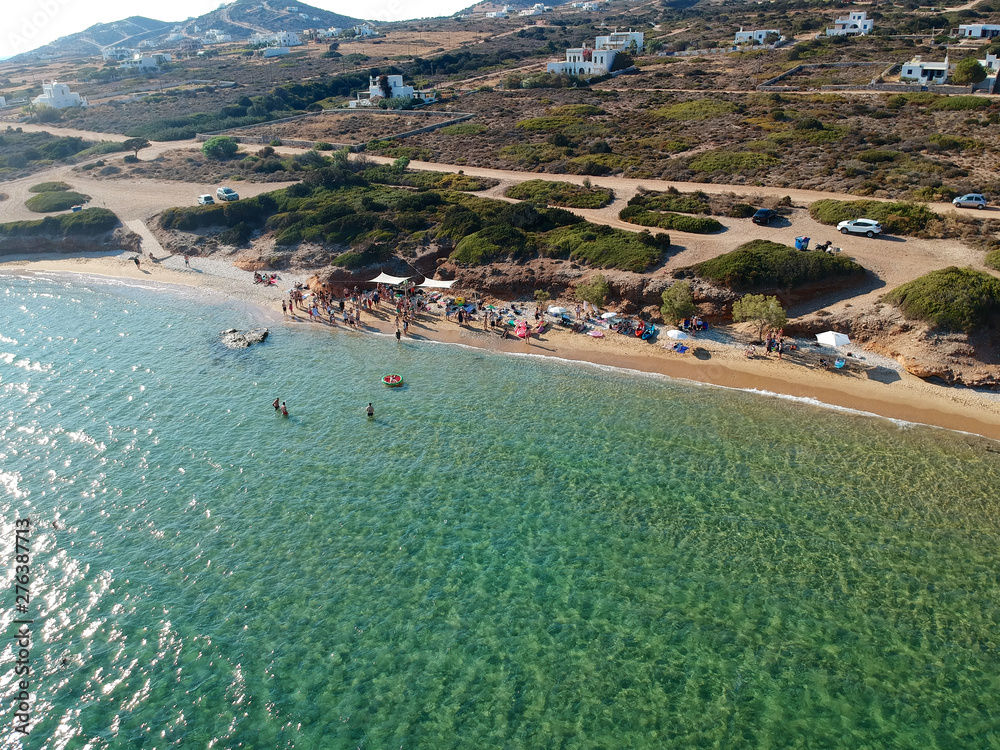 Aerial view group of people enjoying the beach time & party. Group of young people on the beach. blue sea and white sand beach in Greece.