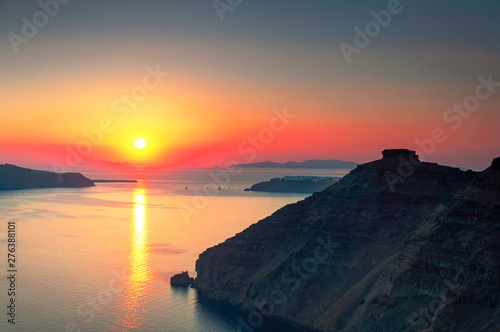 Beautiful sunset overlooking the Aegean Sea  island of Santorini  Greece  Europe. View of the rocks  caldera  volcano  islands  the setting sun sets in the sea. Famous travel destination