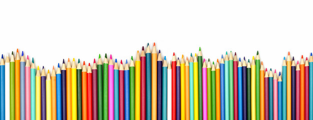 Colored pencil long wavy border. Top view isolated on a white background with copy space. Back to school concept.