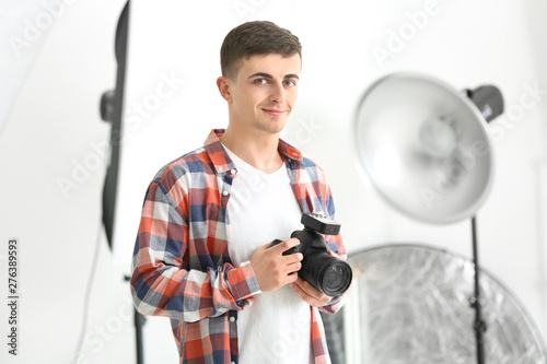 Young male photographer wor...