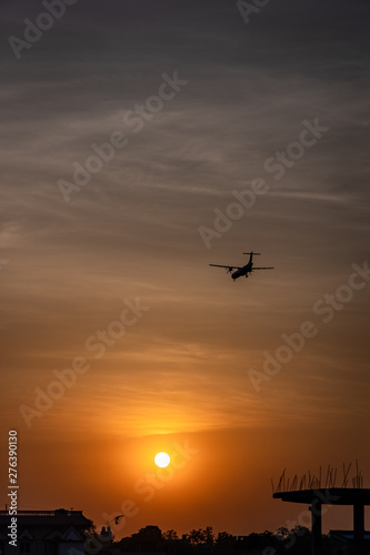 Airplane taking off or landing during sunset © asiraj