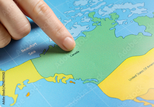 Woman pointing at Canada on...