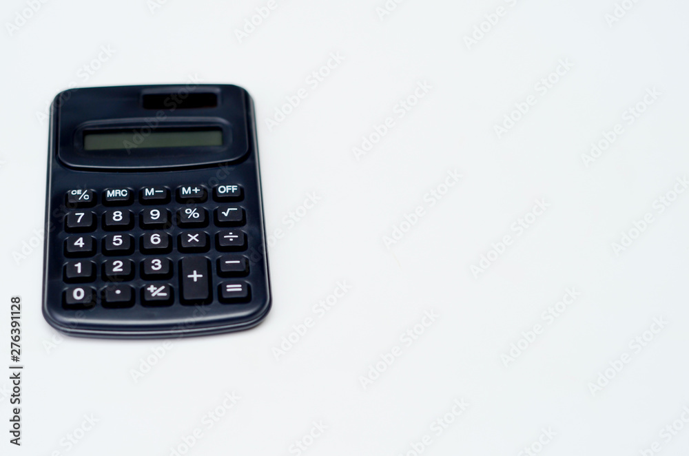 Black calculator placed isolated on a white background.Copy space. Black calculator placed isolated on a white background.Copy space.