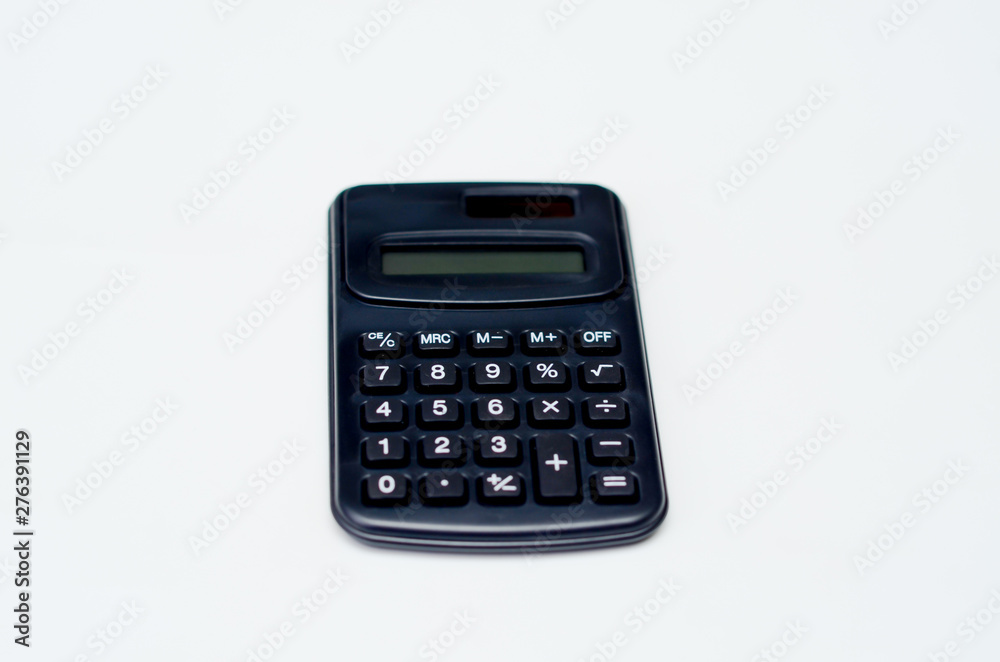 Black calculator placed isolated on a white background.Copy space. Black calculator placed isolated on a white background.Copy space.
