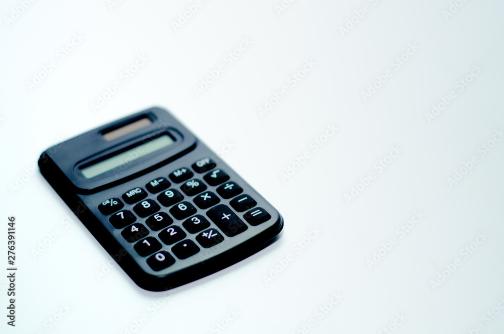 Black calculator placed isolated on a white background.Copy space. Black calculator placed isolated on a white background.Copy space.