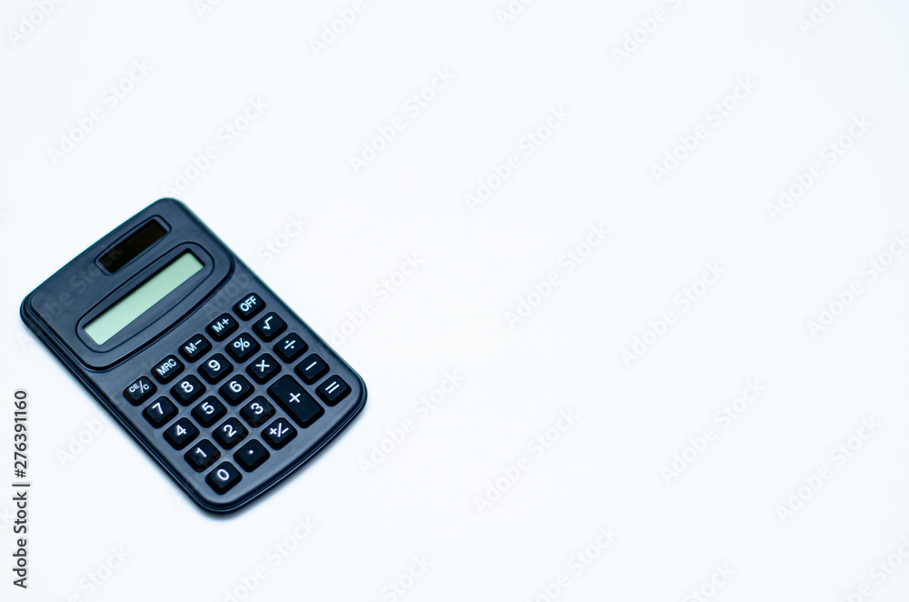 Black calculator placed isolated on a white background.Copy space. Black calculator placed isolated on a white background.Copy space.