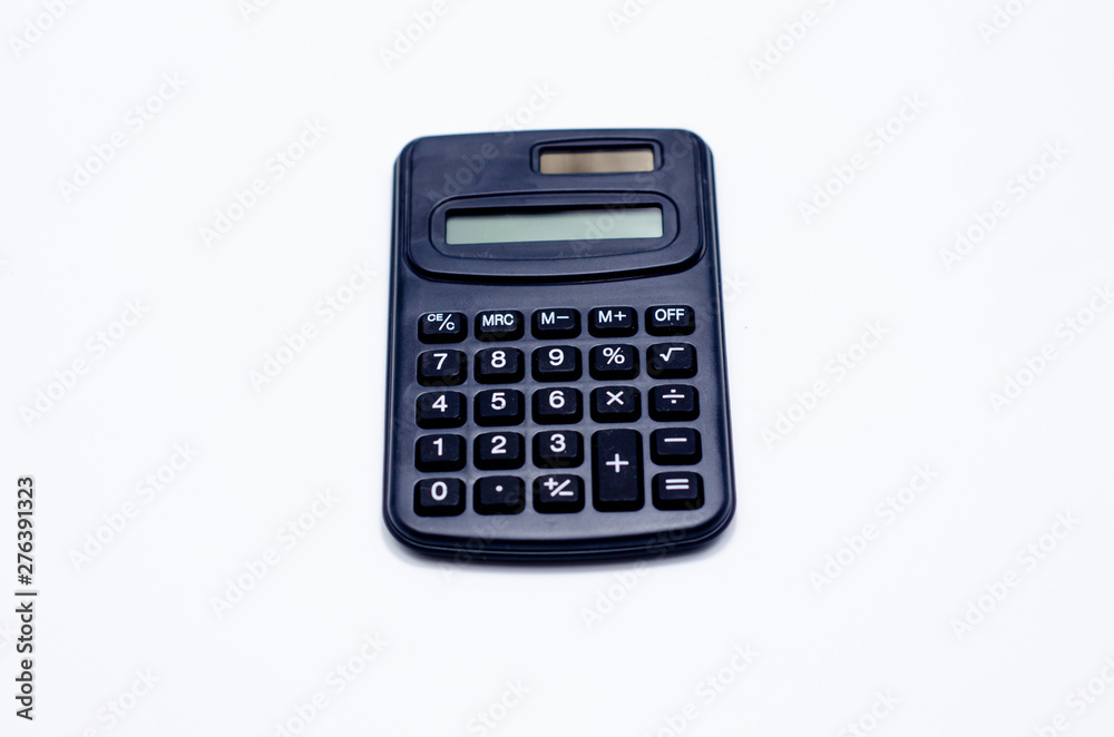 Black calculator placed isolated on a white background.Copy space. Black calculator placed isolated on a white background.Copy space.