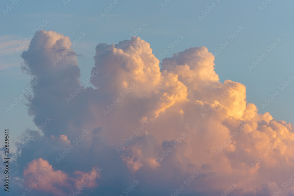 Beautiful colored dramatic cumulus fluffy clouds on blue sky at sunset - obrazy, fototapety, plakaty 