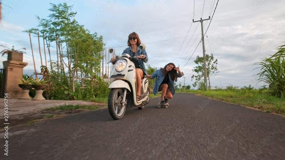 Group of friends skating and motorcycling. Cheerful teenagers having fun outdoors. Two women riding on a sunny day. Happy young couple having fun with skateboard on the road. Group of friends skating and motorcycling. Cheerful teenagers having fun outdoors. Two women riding on a sunny day. Happy young couple having fun with skateboard on the road.