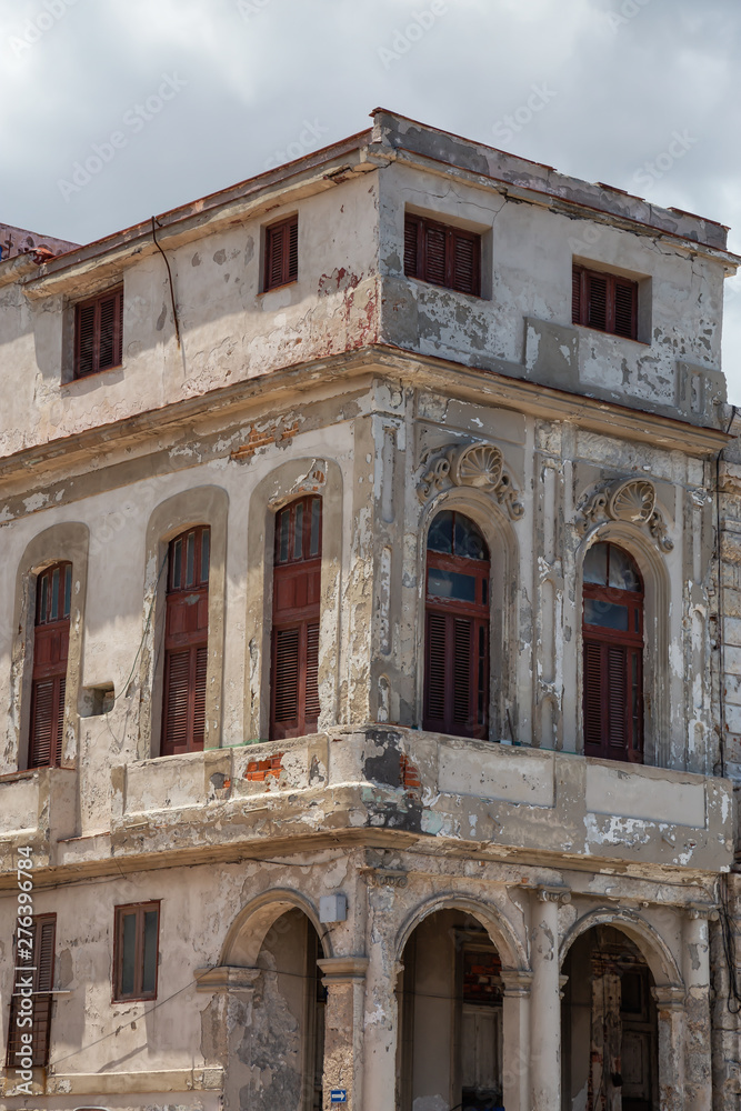 View of the ancient residential homes in the Old Havana City, Capital of Cuba, during a cloudy and sunny day.