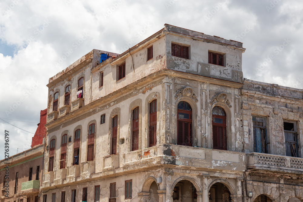 View of the ancient residential homes in the Old Havana City, Capital of Cuba, during a cloudy and sunny day.