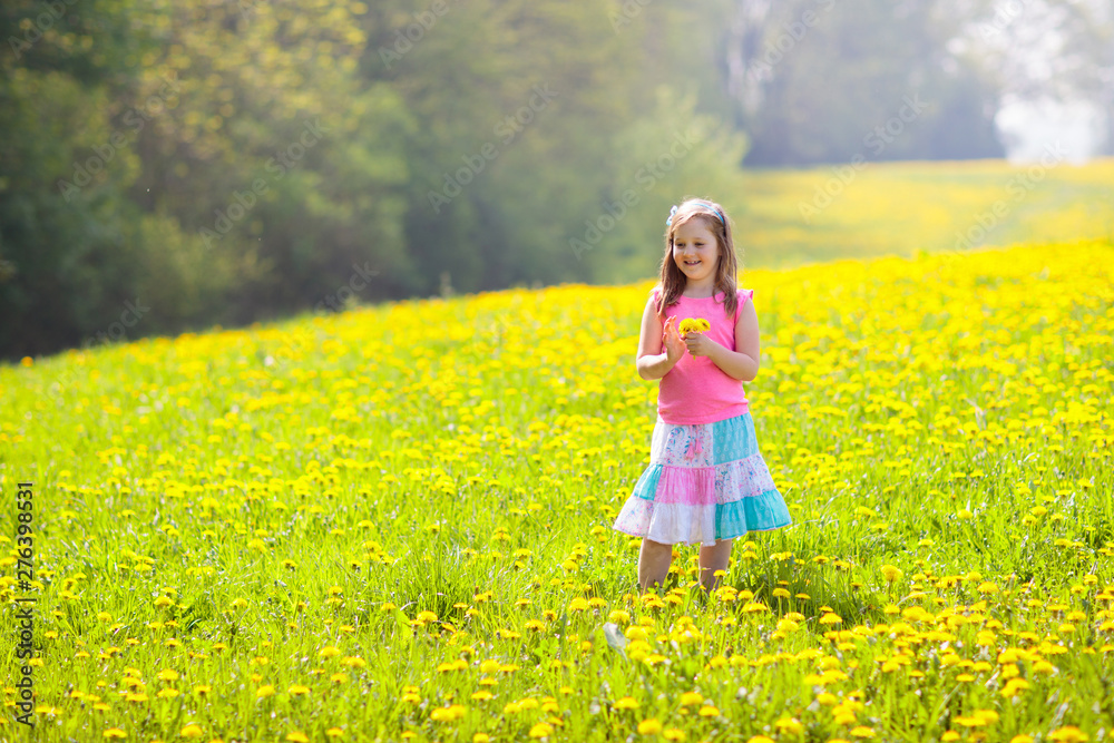 Kids play. Child in dandelion field. Summer flower Kids play. Child in dandelion field. Summer flower