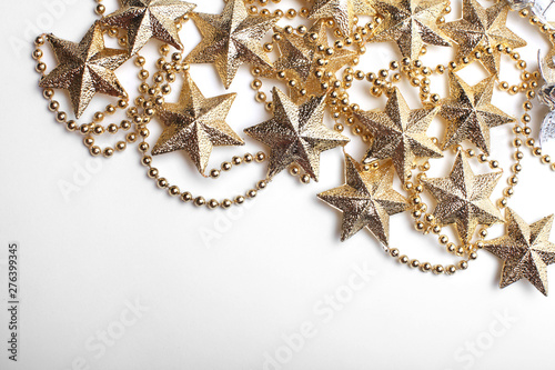 Gold star and bead garland on white backgroun. Flat lay. Top view.