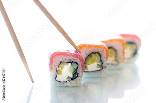 Sushi rolls with chopsticks on the white background. Japanese food close up