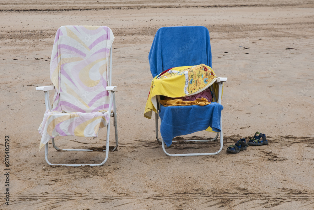 Empty hammocks on the beach with colorful towels Empty hammocks on the beach with colorful towels