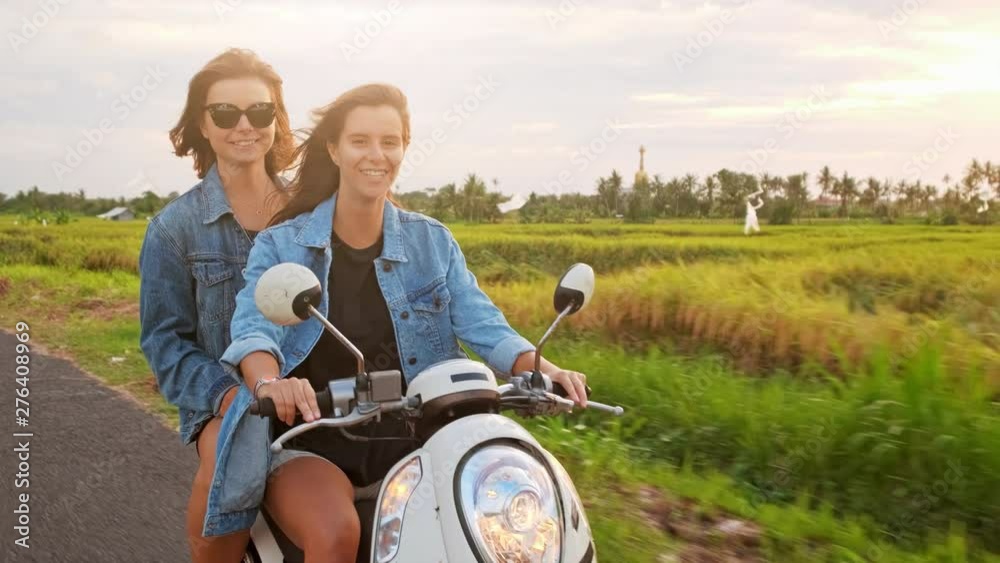 Young attractive couple of fashionable hipsters or millennials driving towards new exciting travel destination on motorbike on mountain forest road. Young attractive couple of fashionable hipsters or millennials driving towards new exciting travel destination on motorbike on mountain forest road.